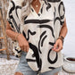 Perfee Printed Notched Half Sleeve Blouse